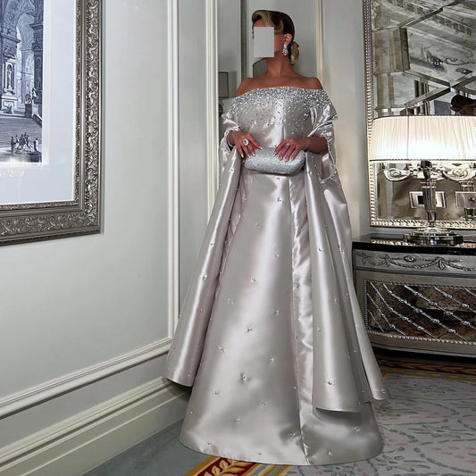 فستان سهرة ملكي تل لامع بتطريز لؤلؤي وأكتاف مكشوفة